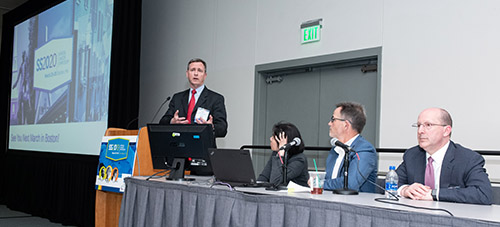 Dr. Bartlett at the podium at the conference