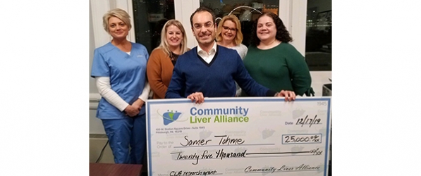 Dr. Samer Tohme holding a giant check from the 3rd Community Liver Alliance in the amount of $25,000