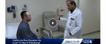 Dr. Humar talking to a patient sitting on an exam table